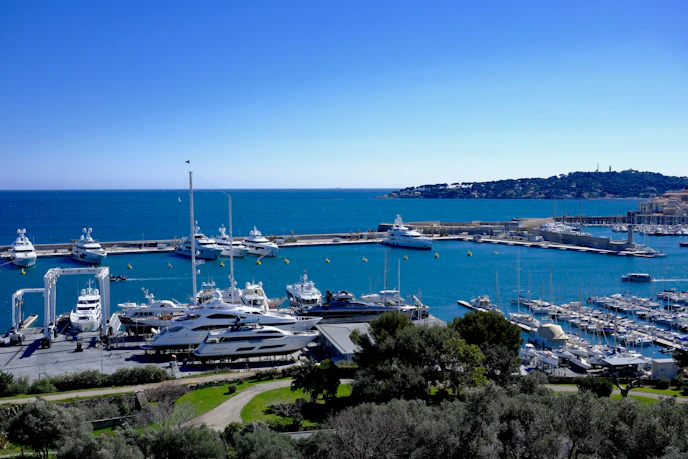 Luxurious yachts are moored in the beautiful harbor.