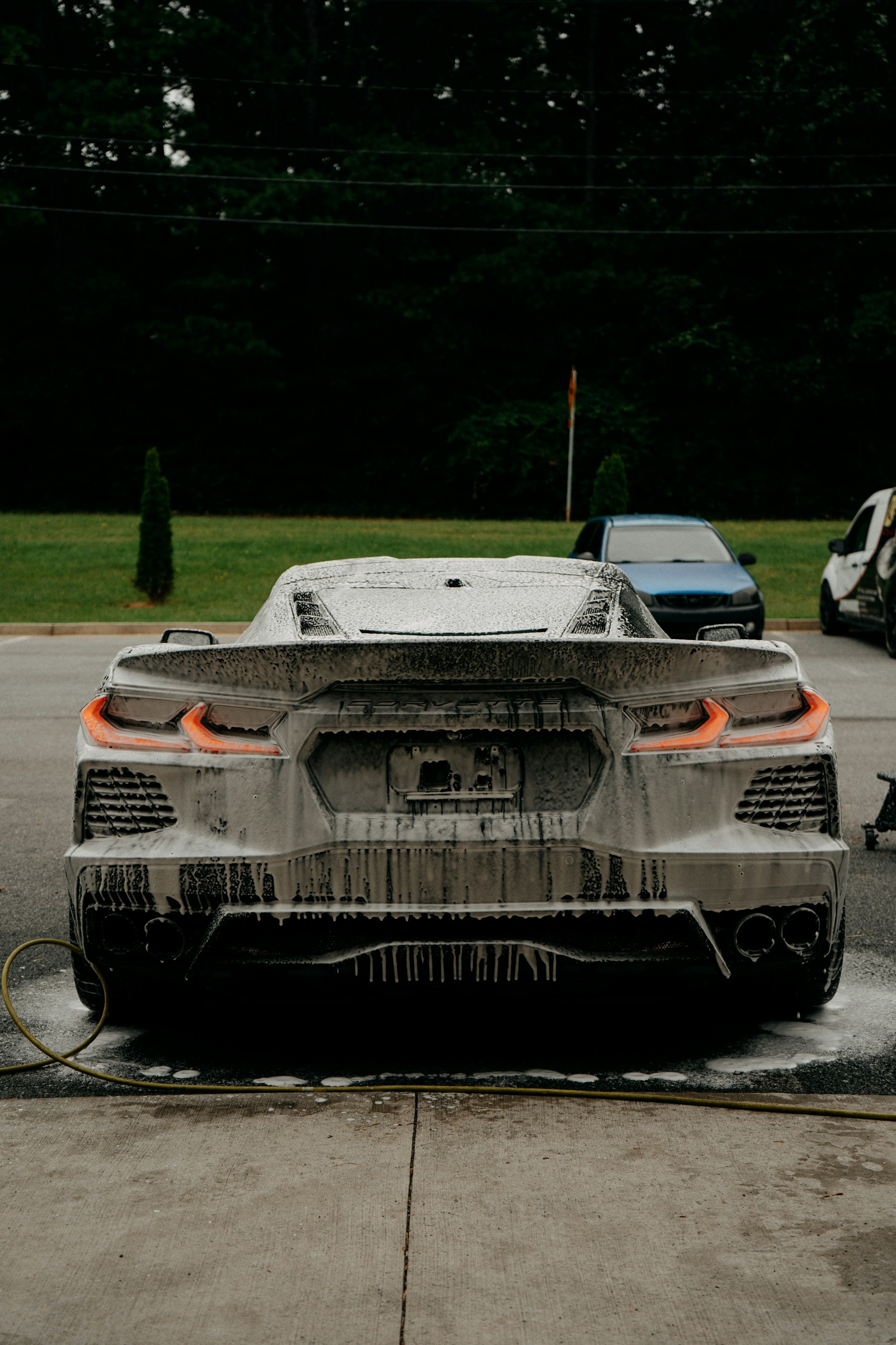 A white car is being washed.