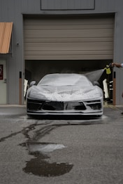 A car is being washed with foam.