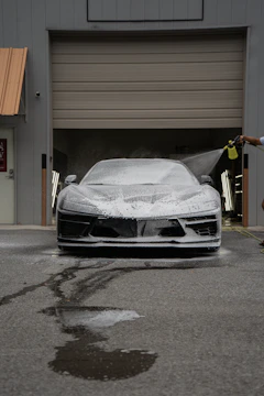 A car is being washed with foam.