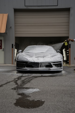 A car is being washed with foam.