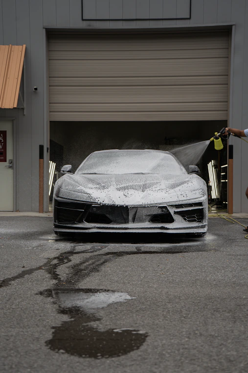 A car is being washed with foam.