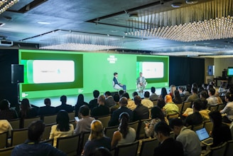 A panel discussion is taking place in front of an audience.