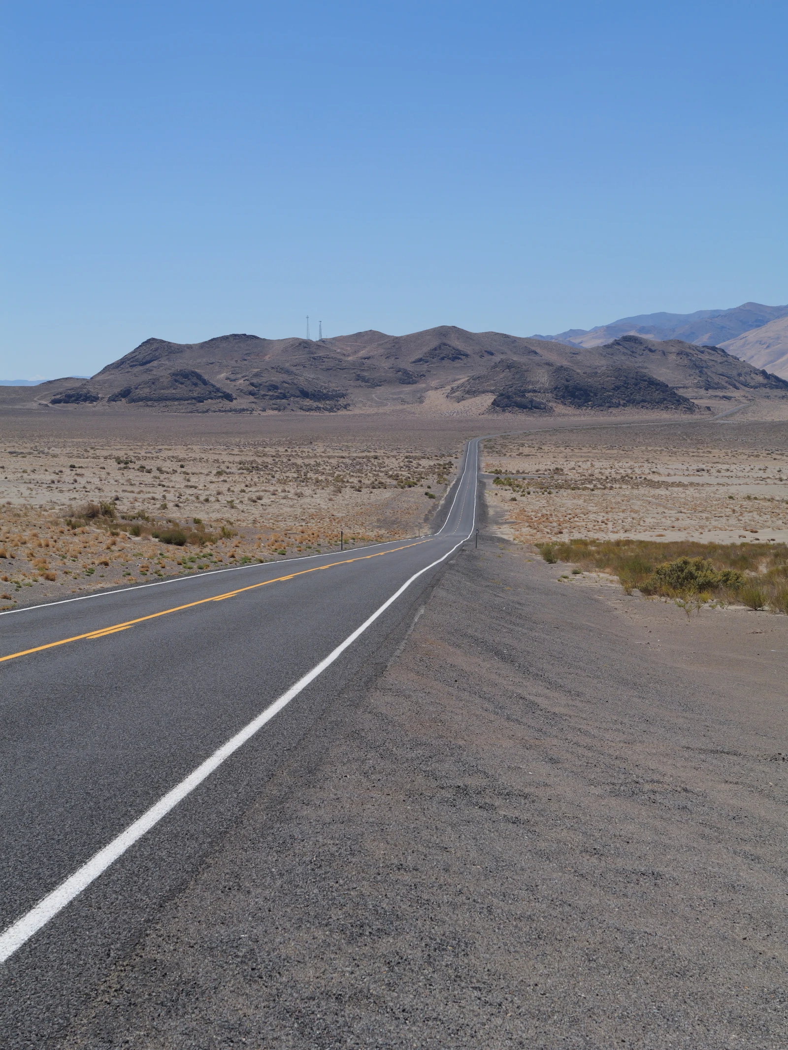 An empty highway crossing open desert.