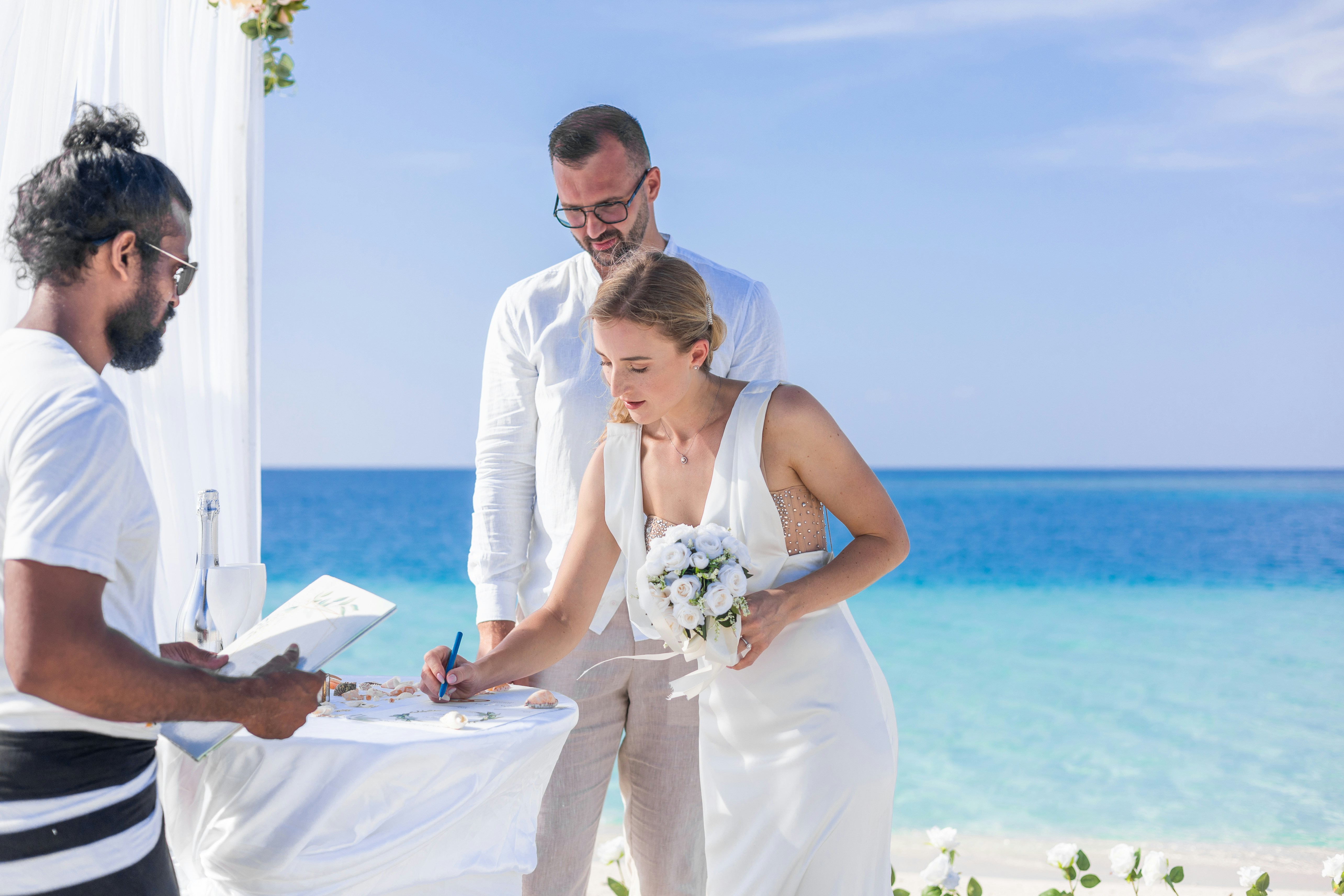 Bride signing wedding papers