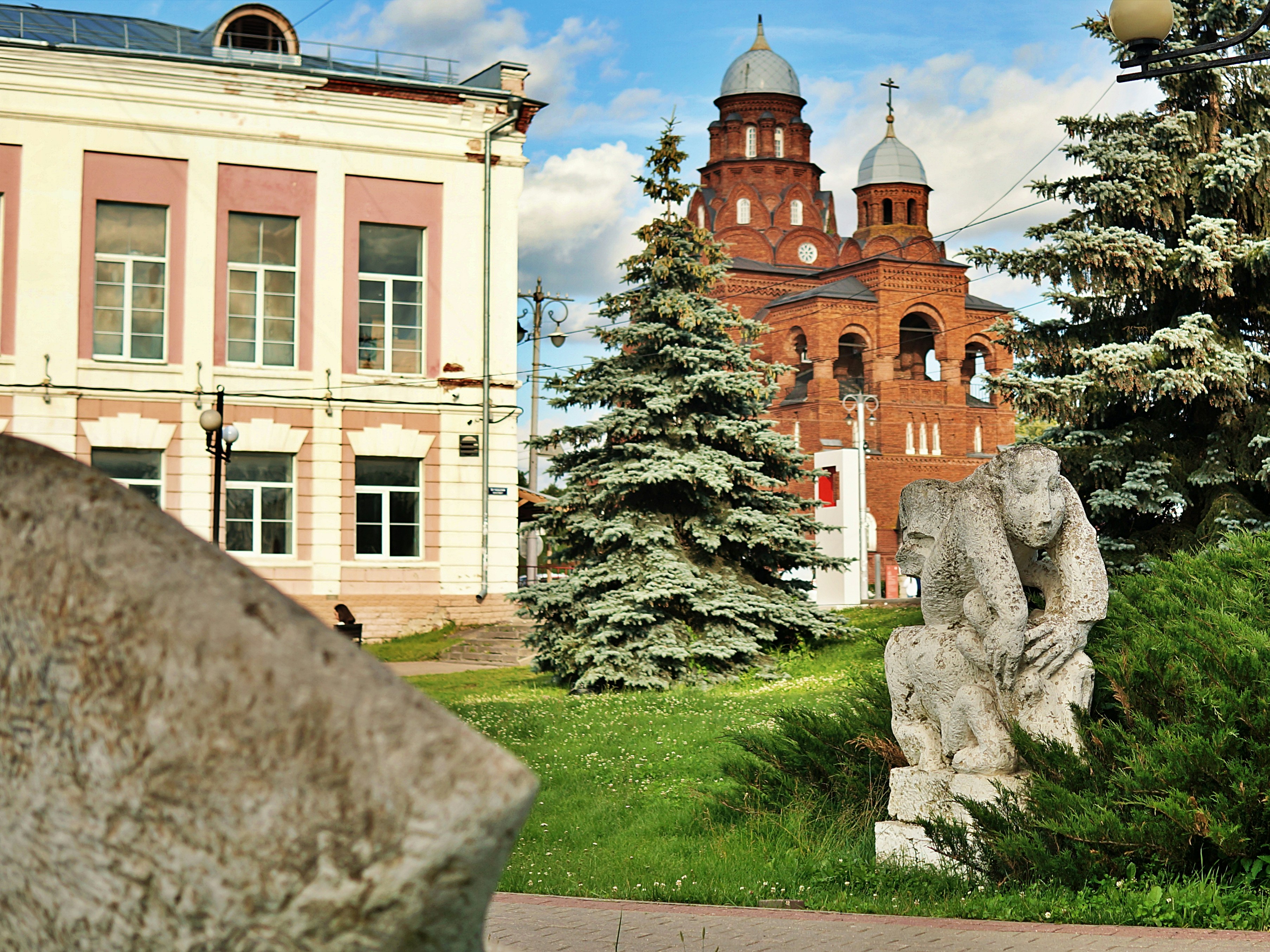 Buildings and a sculpture in a beautiful park.