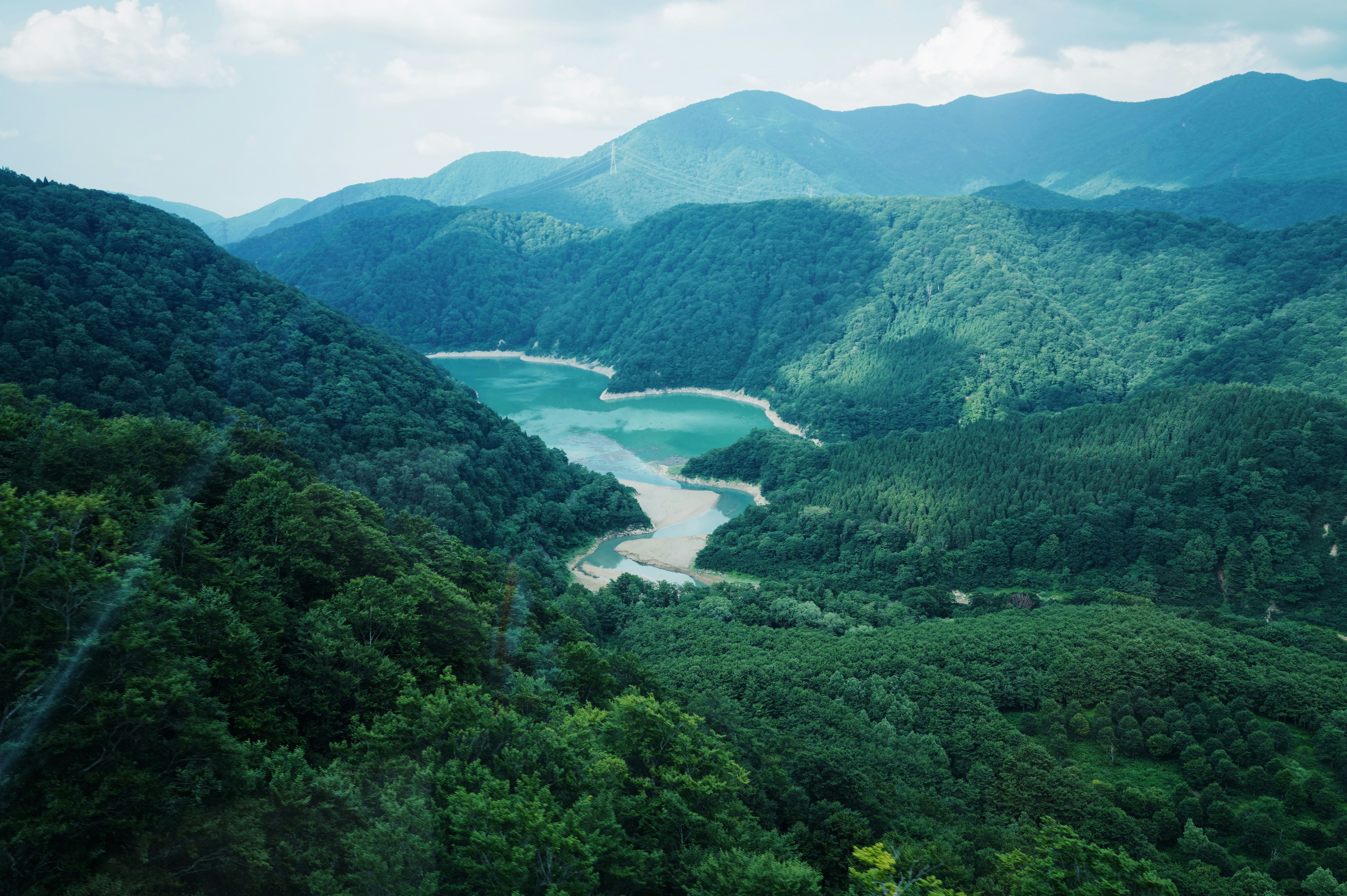 Mountains surround a beautiful, turquoise lake.