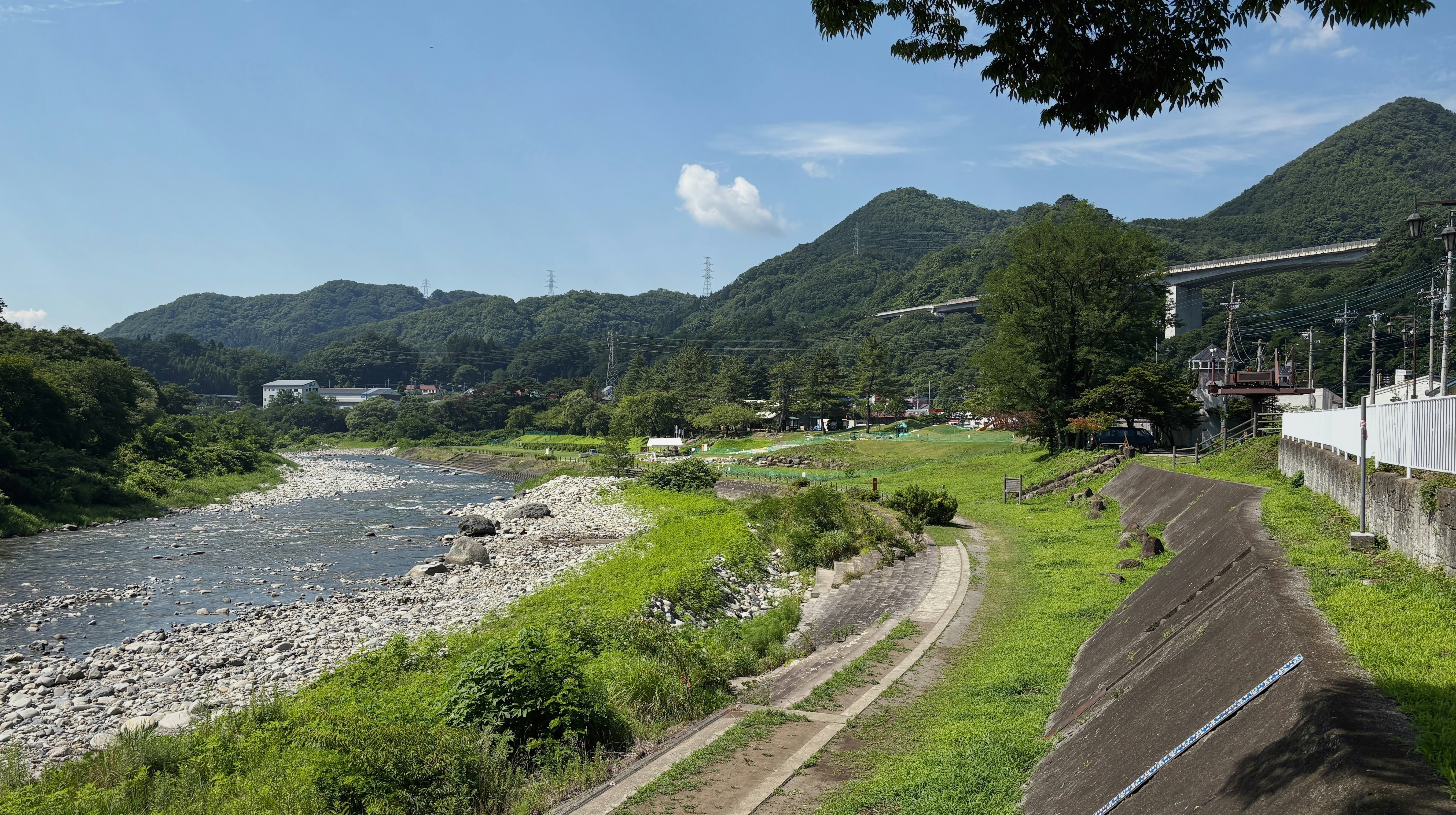 A river flows through a scenic mountain landscape.