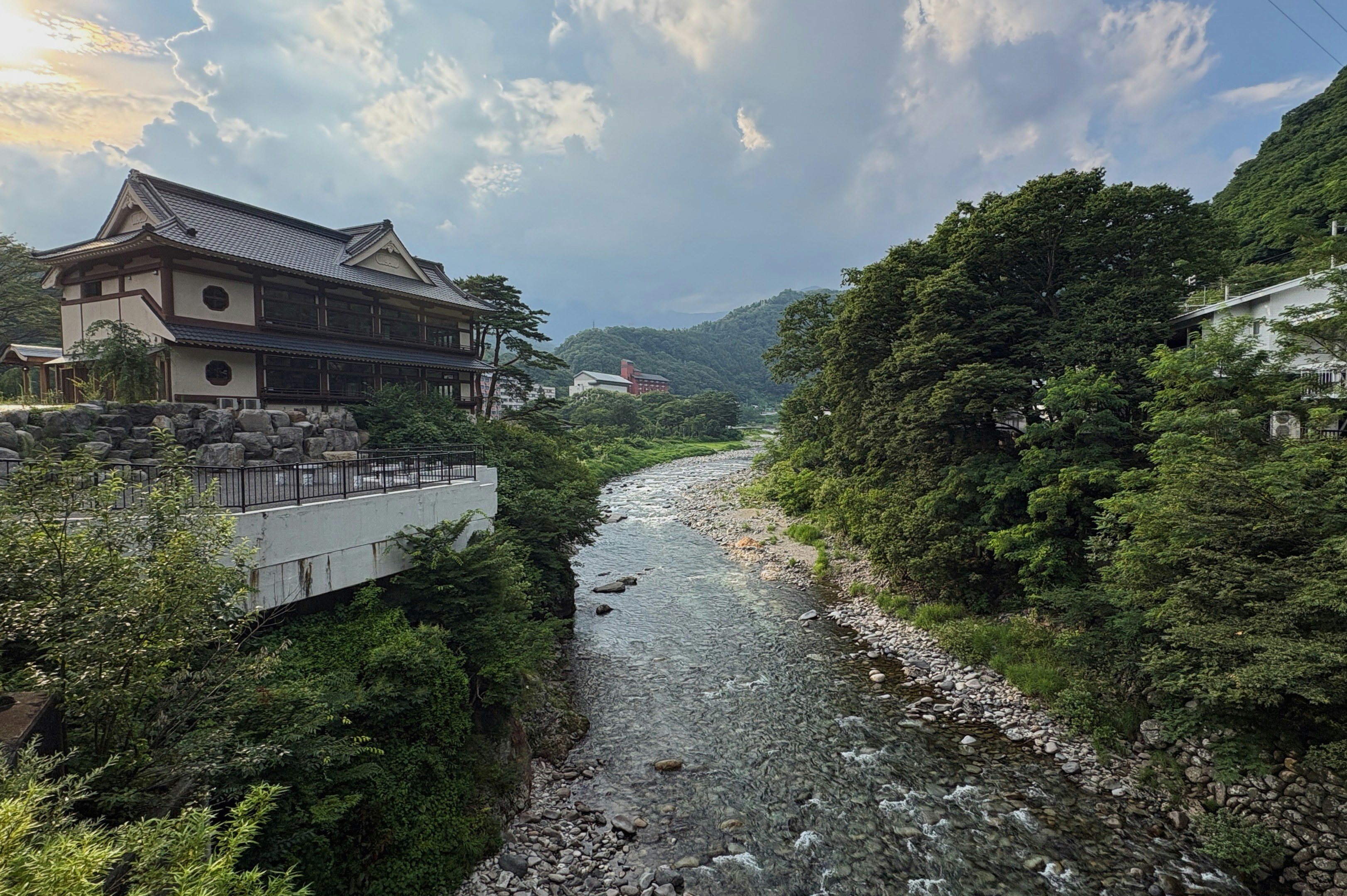 A serene river flows through a picturesque landscape.