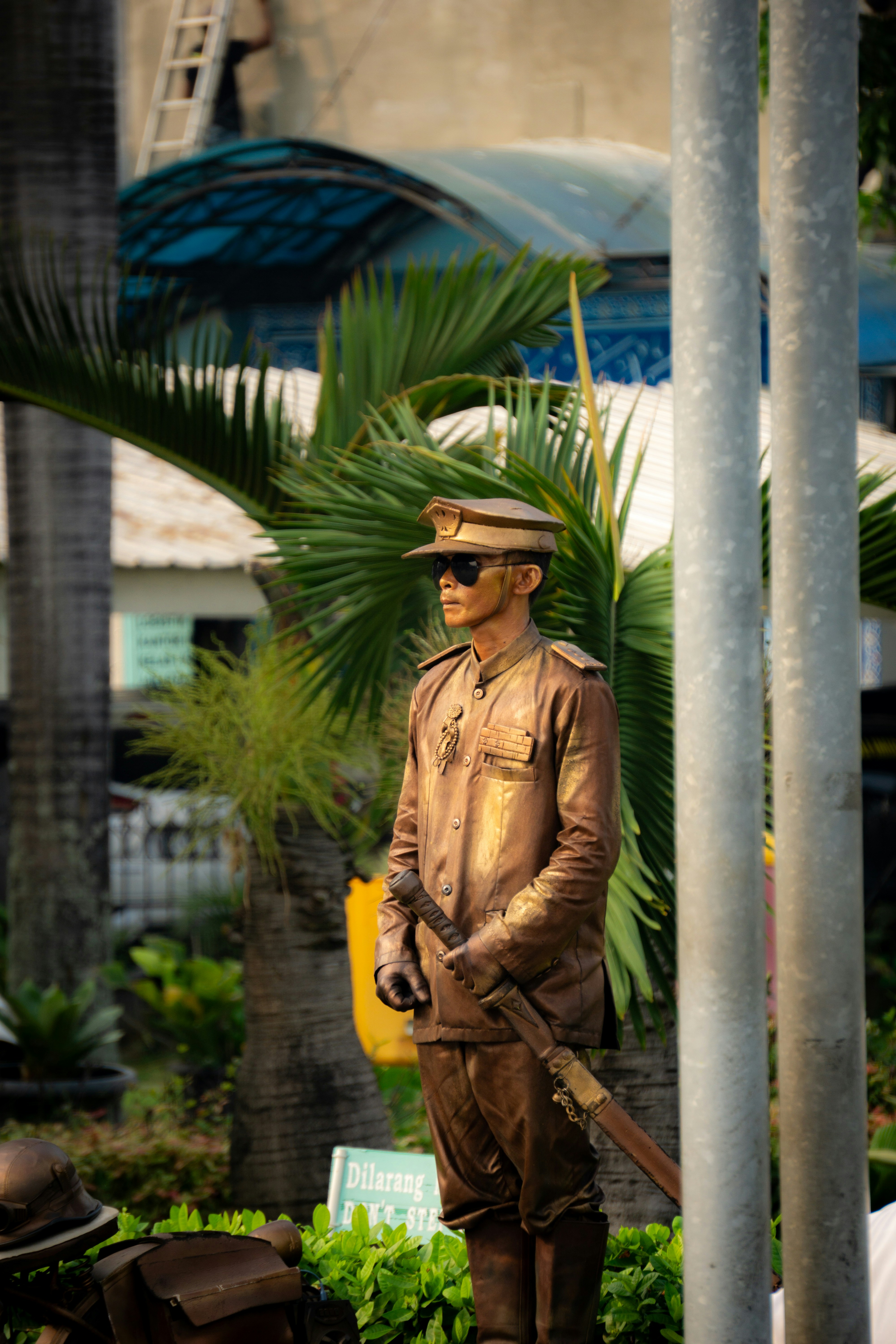 A bronze-colored soldier stands still.