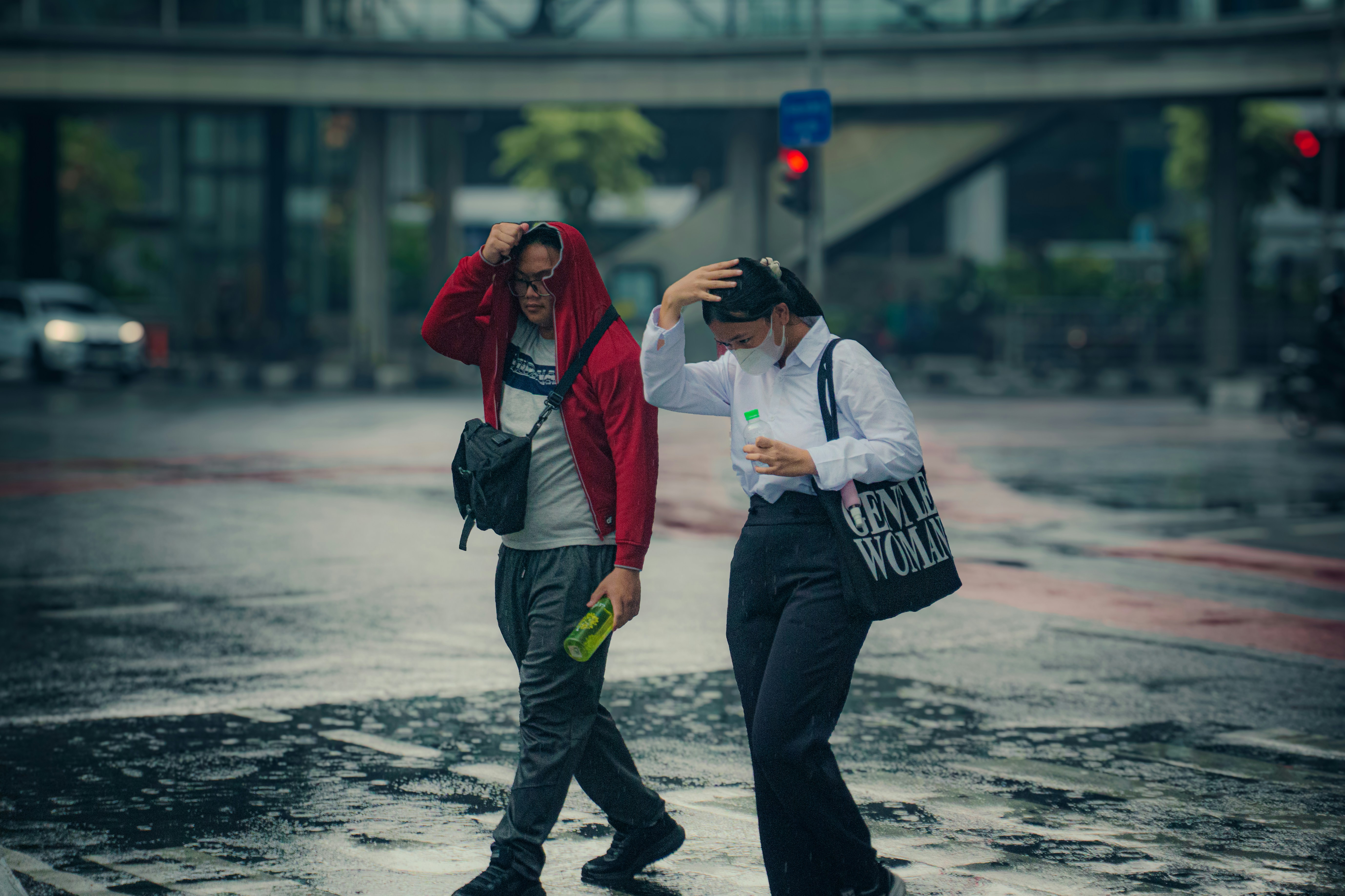 People walk through a flooded street in the rain.
