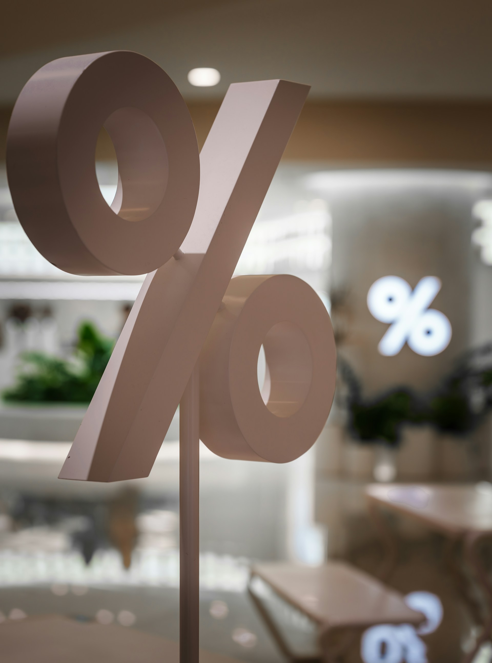 A large percentage sign stands in a store.