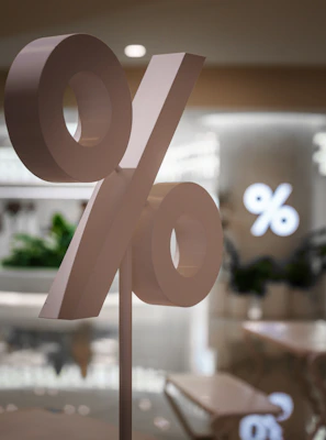 A large percentage sign stands in a store.