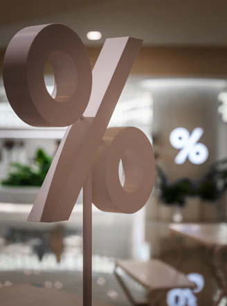 A large percentage sign stands in a store.