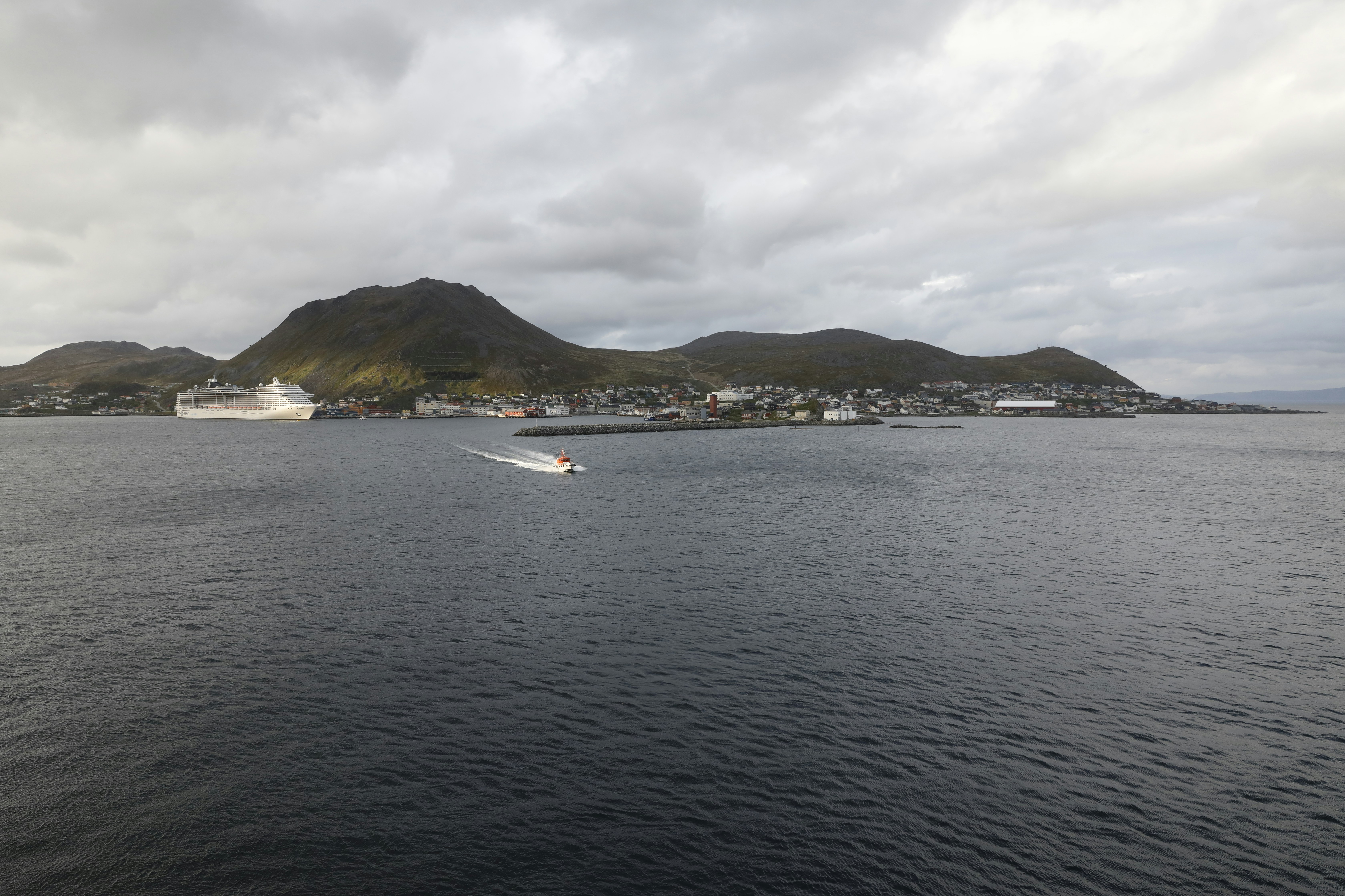 A calm sea leads to a picturesque coastline.