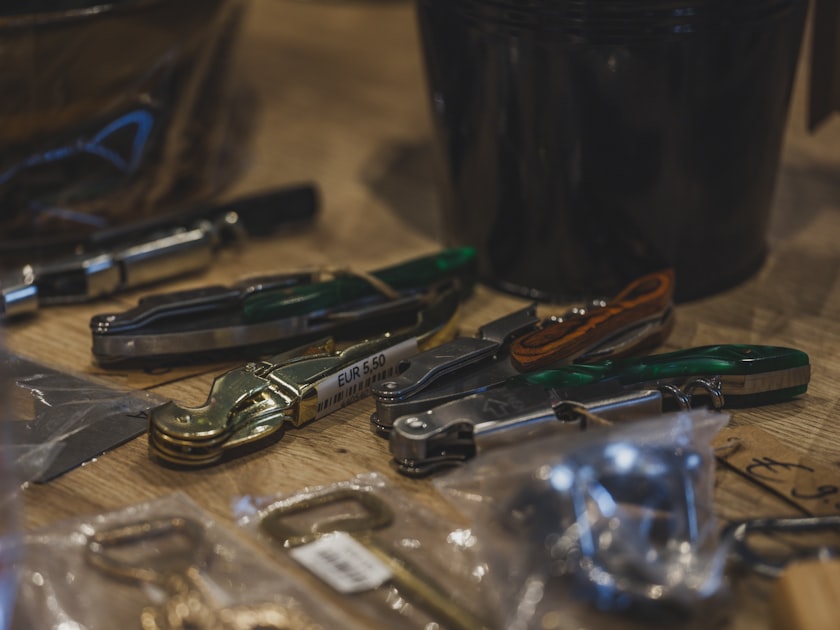 Pocket knives and bottle openers are on display.