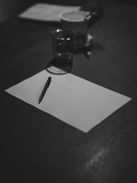 Blank paper and a pen ready for writing.