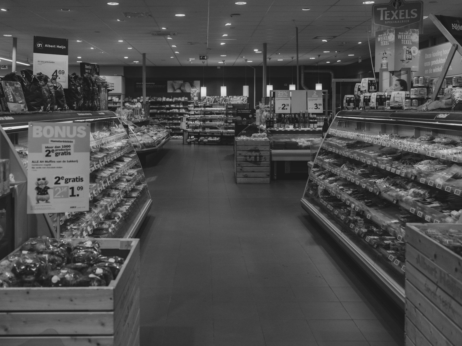 Supermarket floor with aisles and shoppers