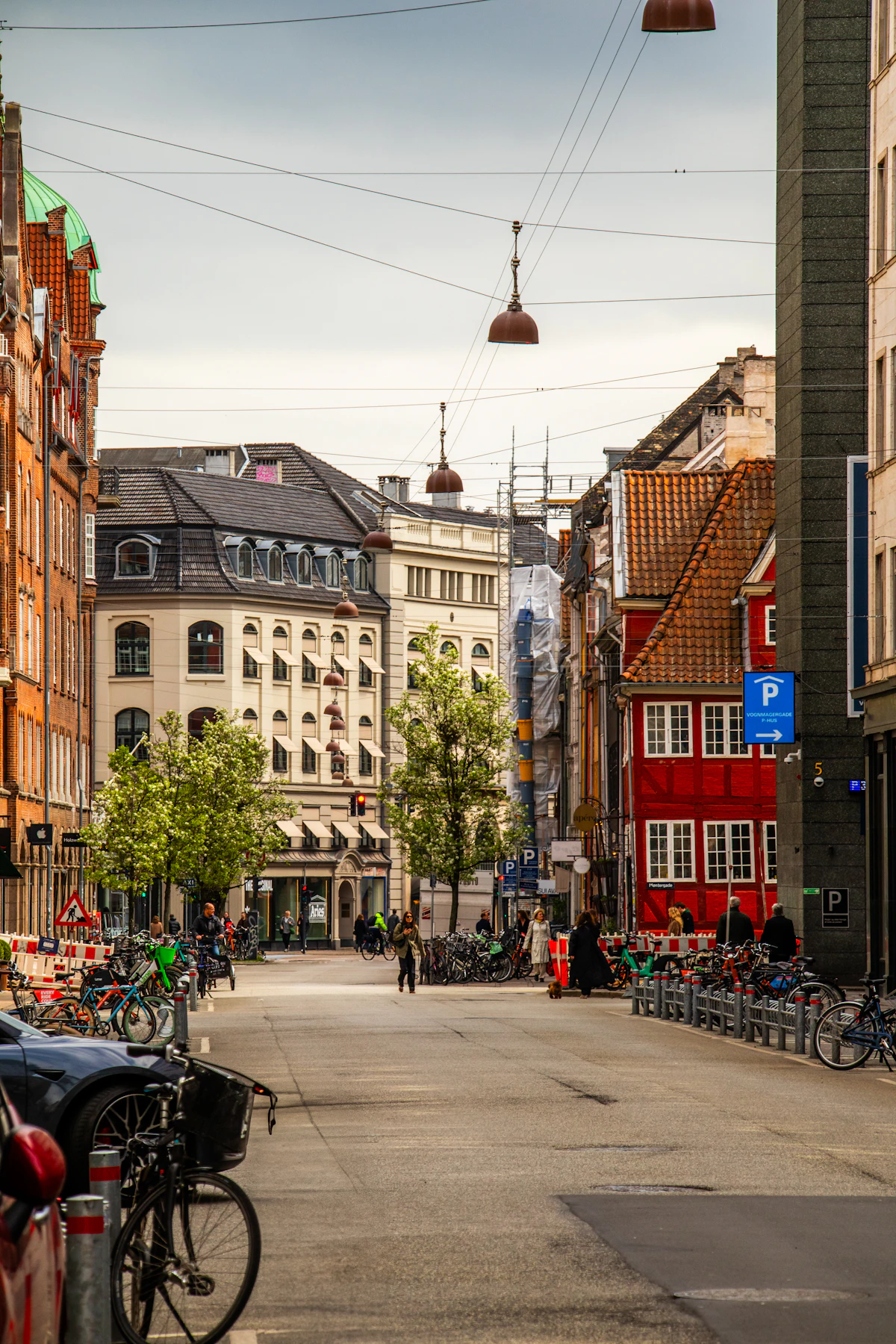 A Copenhagen neighbourhood street lined with bicycles and brick buildings
