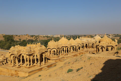 Ancient architecture sits on a desert landscape.