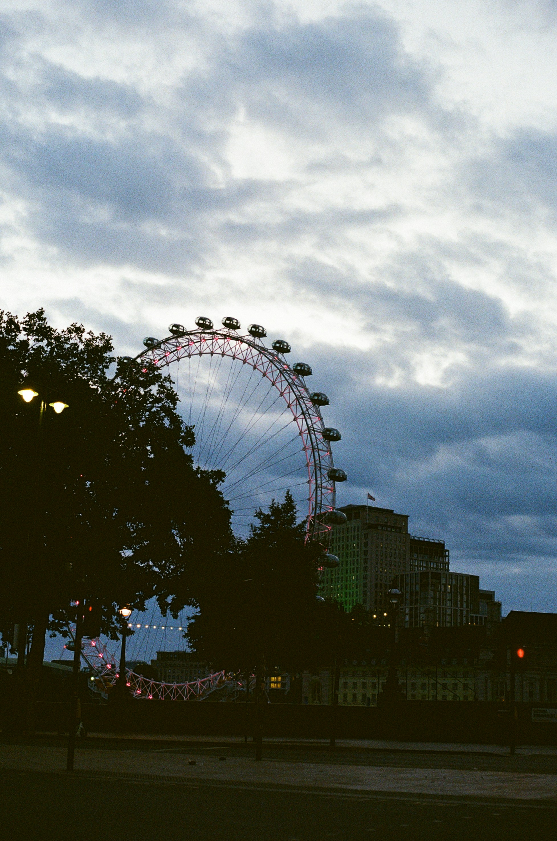 London eye under a moody, cloudy sky.
