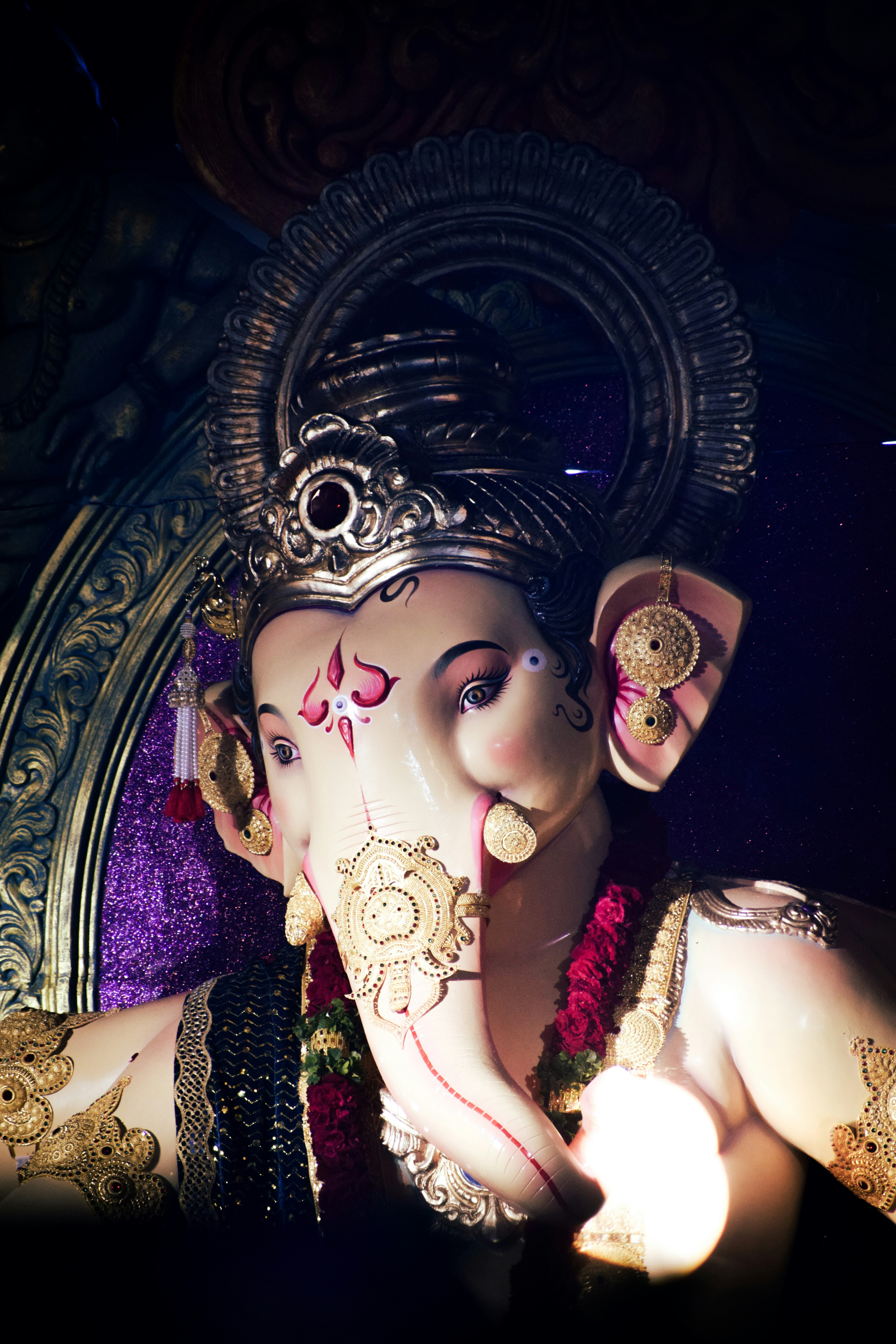 A close-up of a beautifully decorated statue of ganesh.