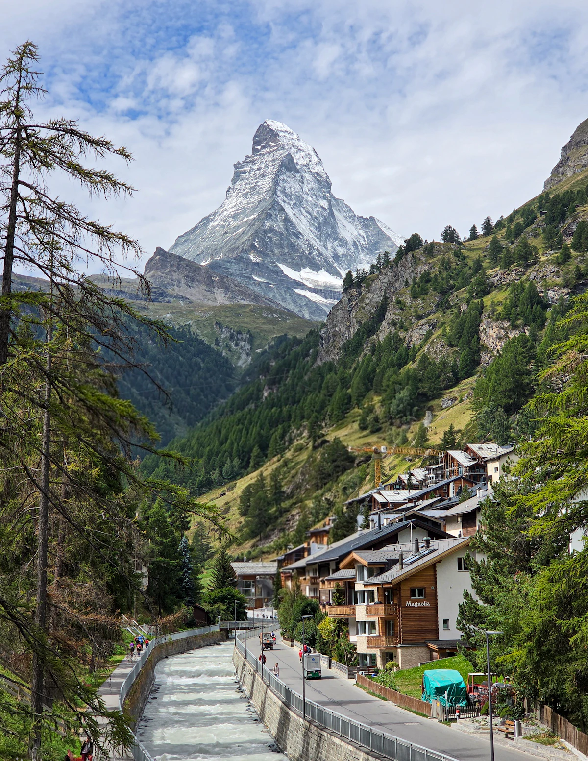 The Matterhorn above Zermatt, its chalets and the river running through the village