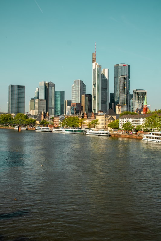 Frankfurt skyline and Main river with sightseeing boats moored near the Altstadt riverbank