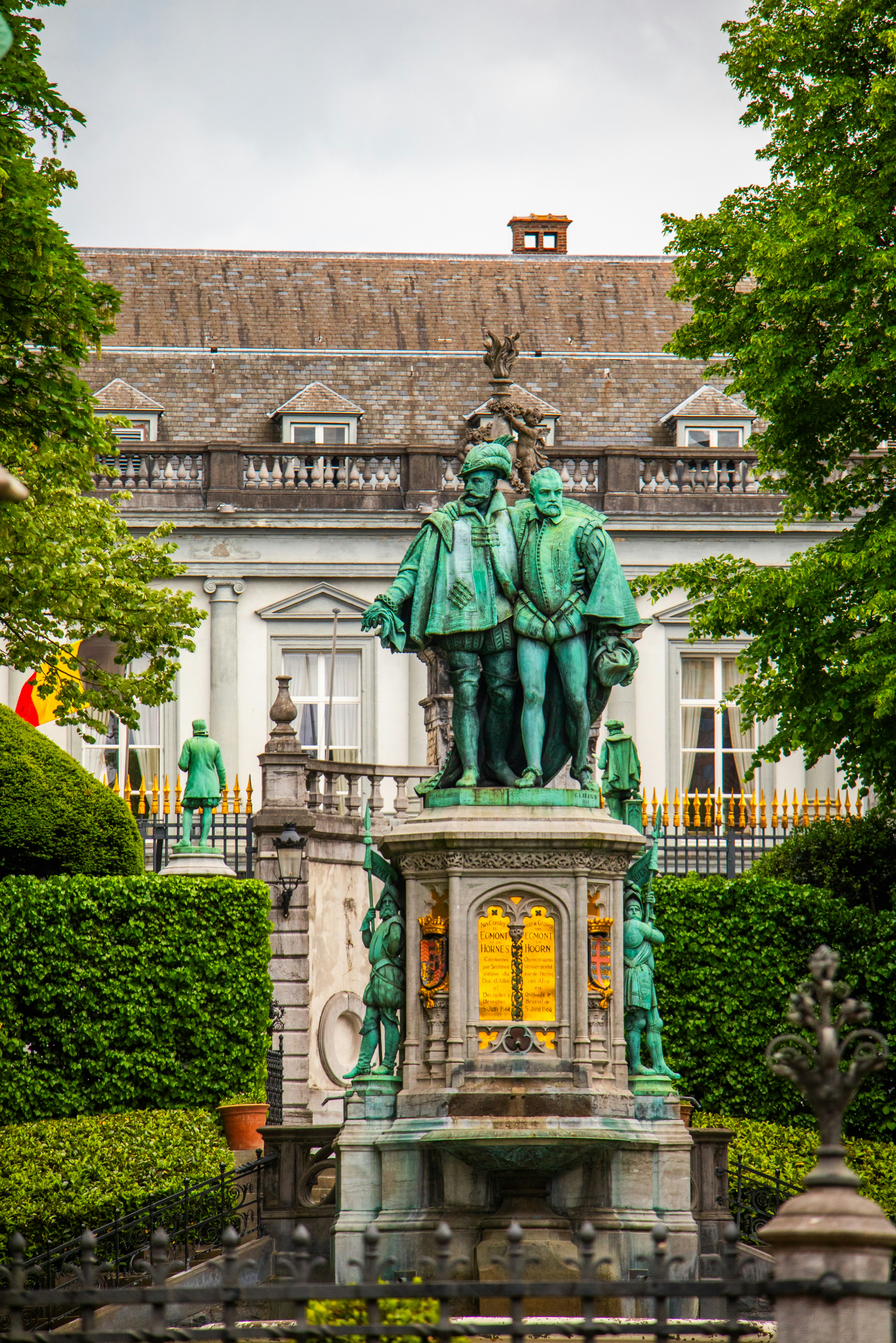 Statue and building are seen outdoors.