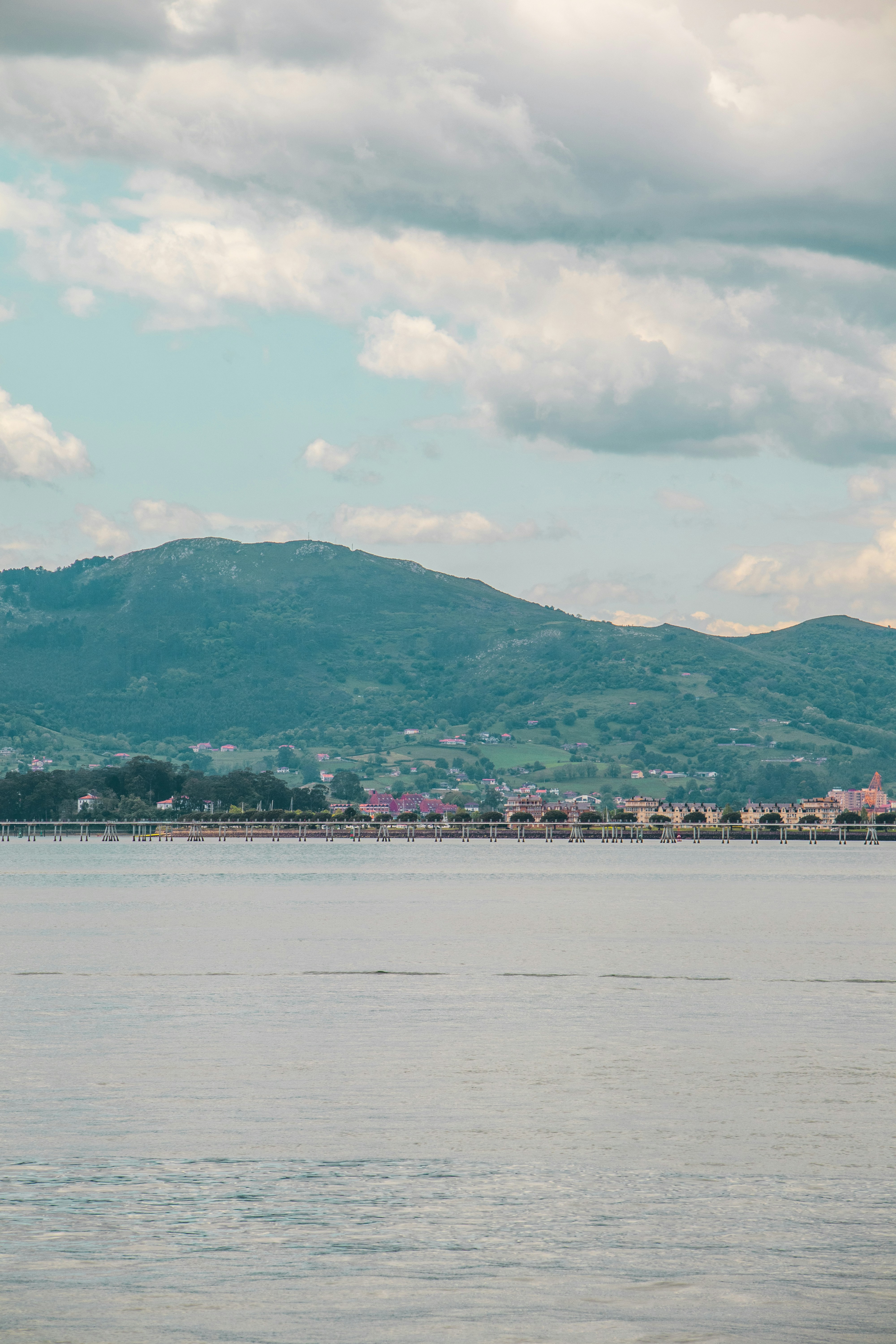 Mountain over a lake under a cloudy sky.