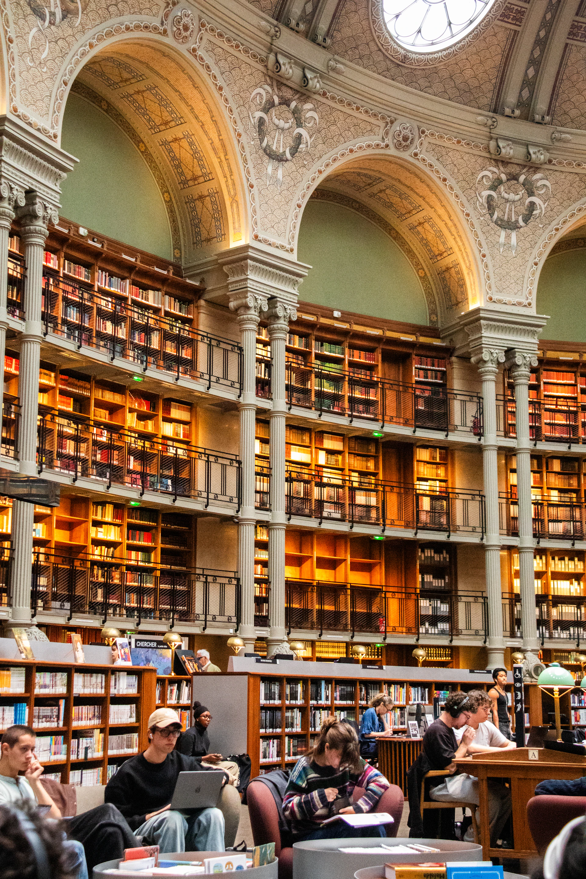 Students study in a grand, ornate library.
