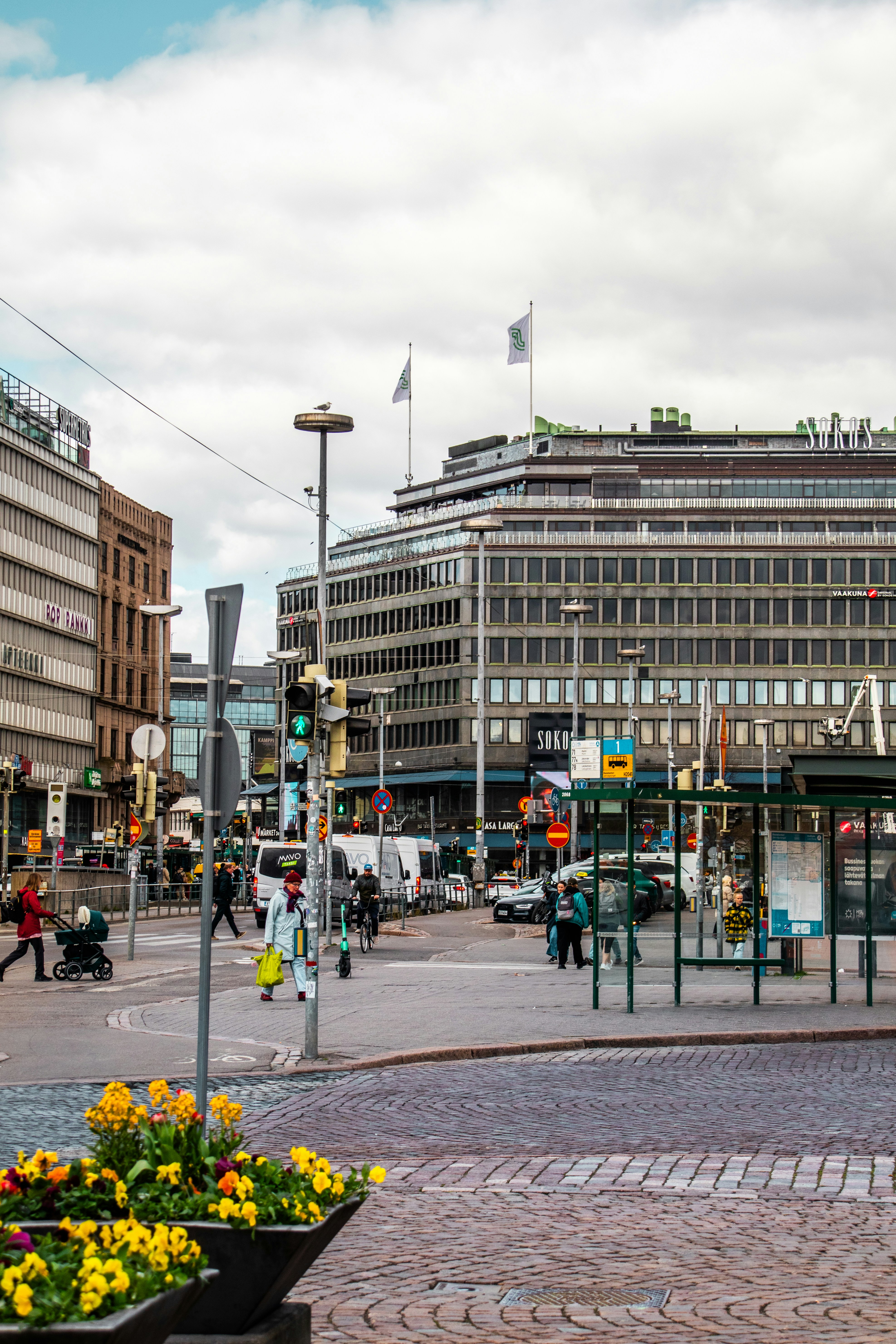 A busy street scene with buildings and people.