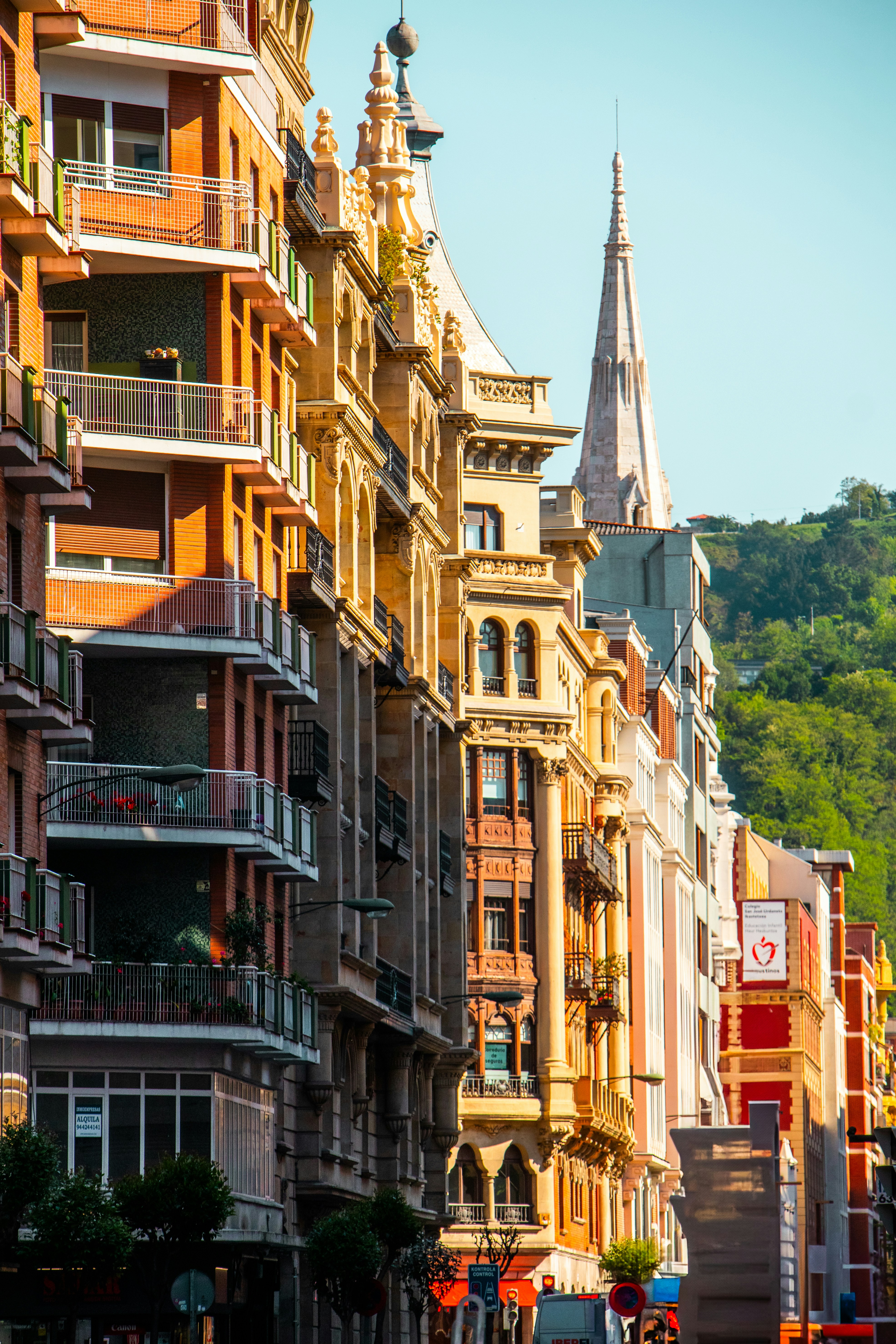 Beautiful european buildings line a sunlit street.