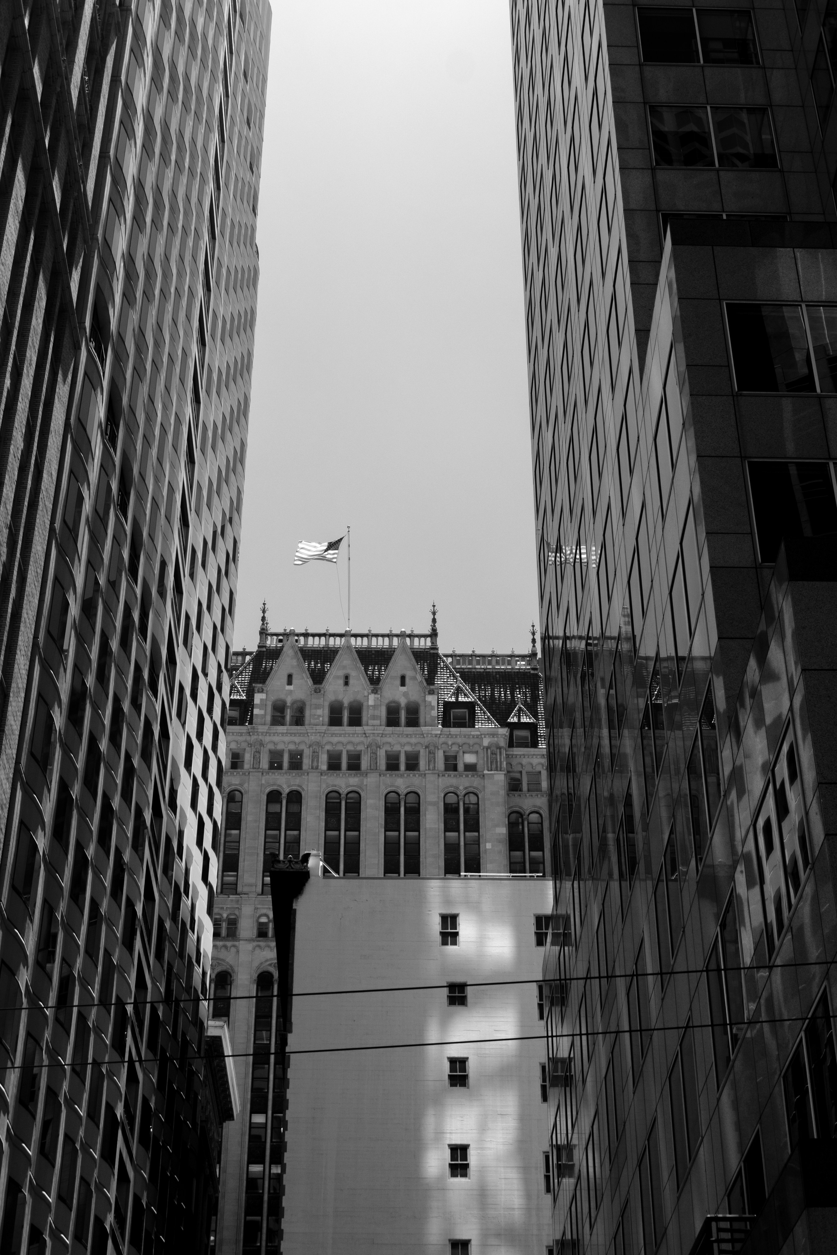 Buildings tower over a city street.