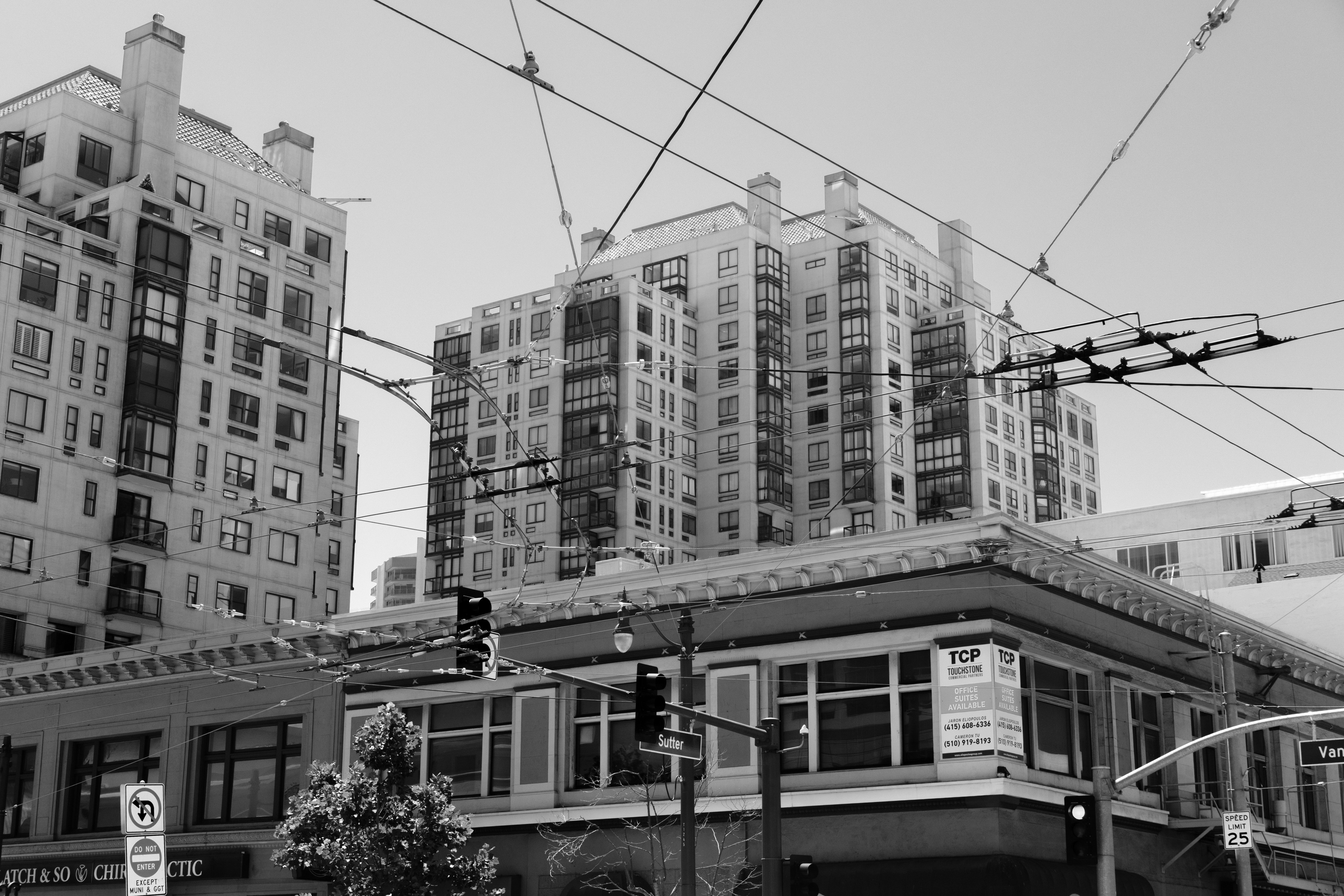 Buildings and wires fill the image in black and white.