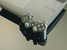 A playstation 3 console and its controller