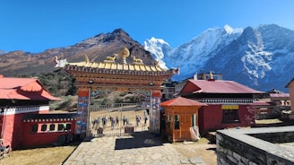A traditional buddhist gate leads to the mountains.