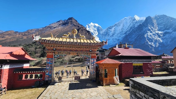 A traditional buddhist gate leads to the mountains.