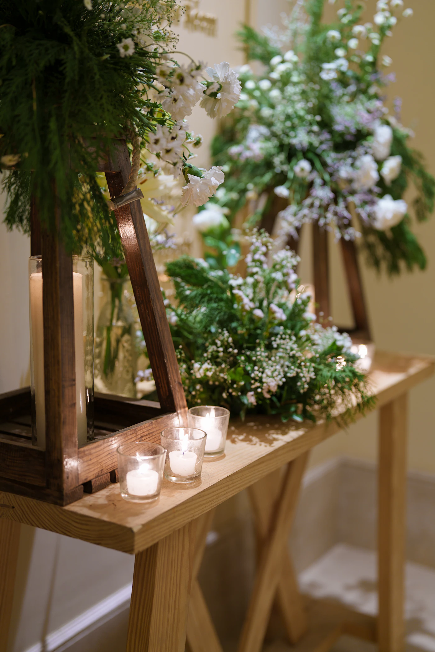An elegant wedding table decorated with colourful floral arrangements and lit candles creating a warm and luxurious atmosphere for an upscale destination wedding reception