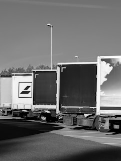 Trucks are parked in a row on a sunny day.