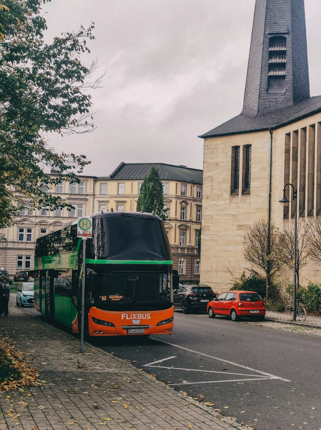 A double-decker flixbus is parked on a street.