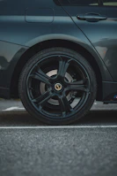 A dark car wheel is showcased.