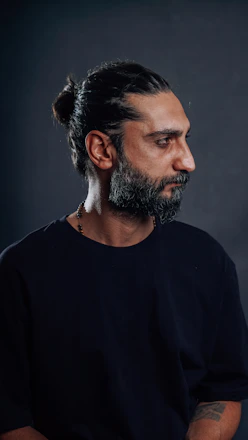 Man with a beard looking off to the side