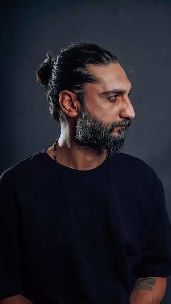 Man with a beard looking off to the side