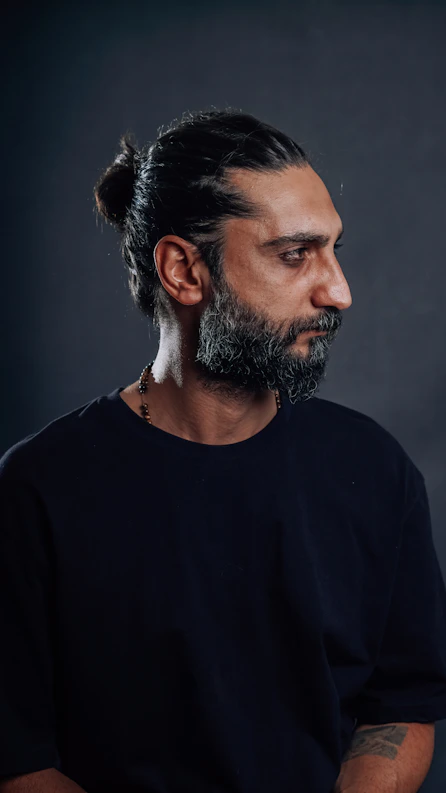 Man with a beard looking off to the side
