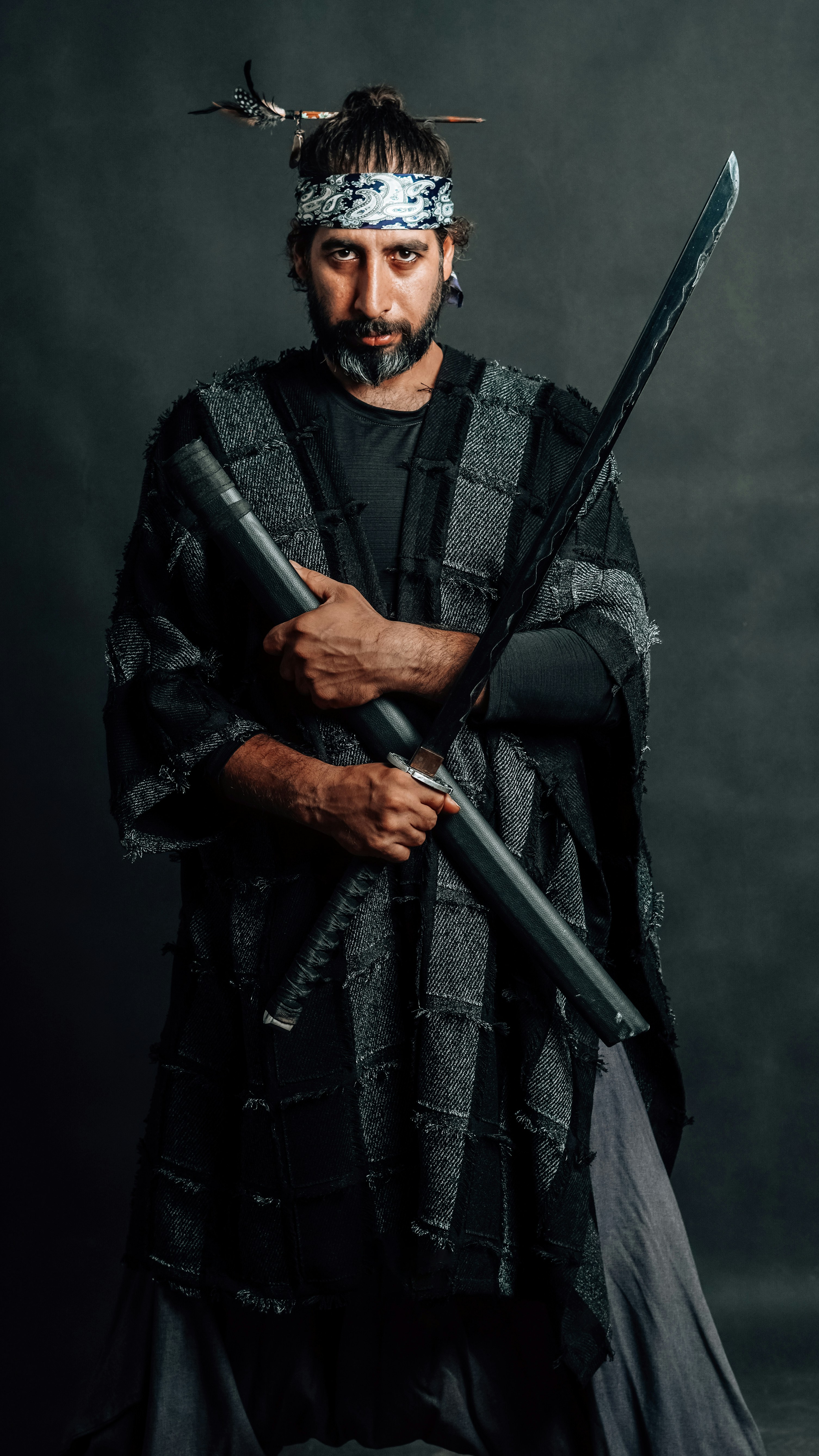 A warrior poses with a sword and scabbard.