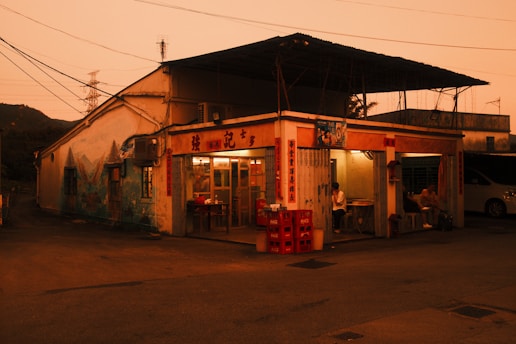 An old restaurant is lit in the dusk.
