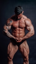 A muscular bodybuilder flexes his biceps.