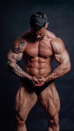 A muscular bodybuilder flexes his biceps.