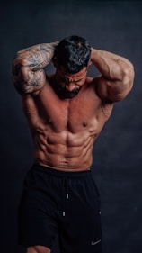 A muscular bodybuilder poses for the camera.